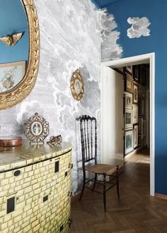 a room with a chair, mirror and other items on the table in front of it