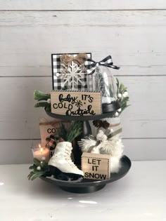 a three tiered cake with snow boots and christmas decorations