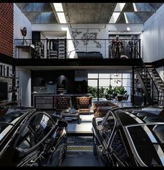 the inside of a building with several cars parked in front of it and stairs leading up to the second floor