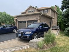 two cars parked in front of a house
