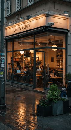a coffee shop is lit up at night