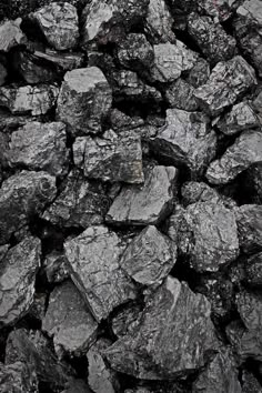 a pile of black rocks sitting next to each other