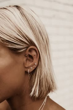 a blonde woman with ear piercings on her ears