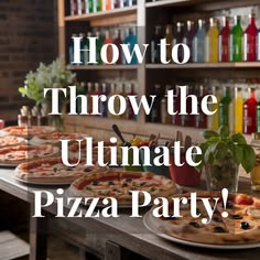 several pizzas sitting on top of a table in front of shelves with bottles and glasses