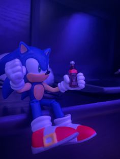 sonic the hedgehog holding a spray bottle in his hand