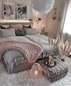 a large bed sitting in a bedroom next to a lamp and pictures on the wall