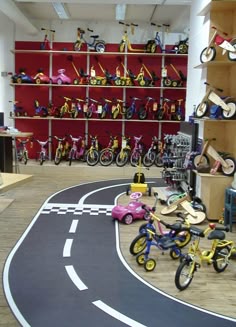 a room filled with lots of toy bikes and toys on shelves next to each other