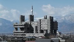 a large building that is next to some mountains