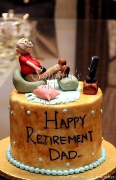 there is a cake that says happy retirement dad on the top and an image of a man sitting in a chair