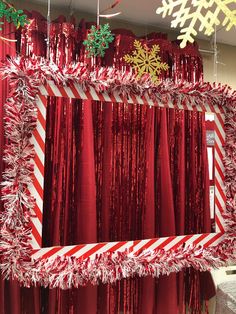 a red and white curtain with snowflakes on it