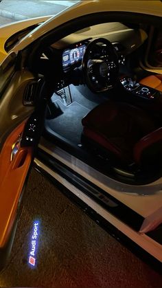 the interior of a sports car with its lights on