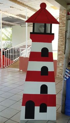 a red and white lighthouse made out of cardboard