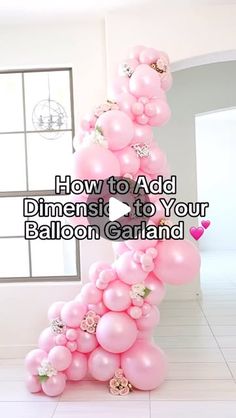 pink balloons are stacked up in the shape of a number one with flowers on them