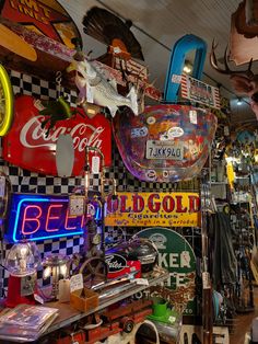 there are many neon signs on display in this shop, and one is for sale