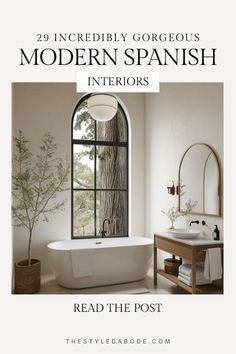 a white bath tub sitting under a window next to a sink and mirror with the words modern spanish interiors read the post
