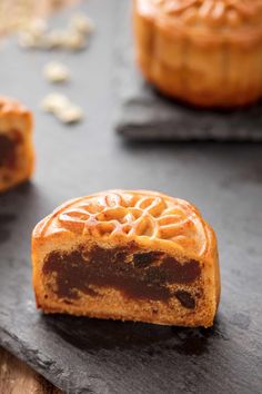 two desserts sitting on top of a wooden cutting board next to eachother