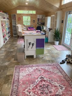 a living room filled with lots of furniture and rugs