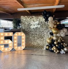 the 50th birthday party is decorated with balloons, lights and letters that spell out 50