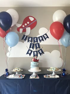 an airplane themed birthday party with balloons and cake