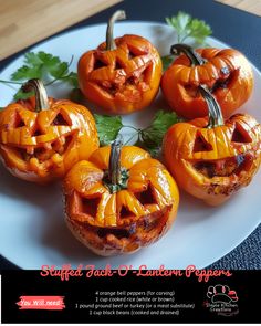 four carved pumpkins sitting on top of a white plate