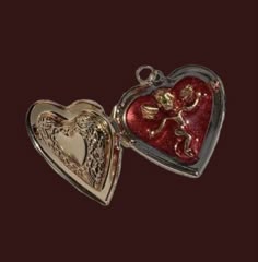 two heart shaped lockes with angels and hearts on the front, one is red