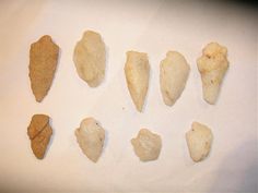 seven different types of rocks on a white surface