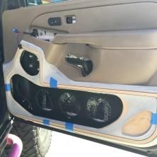 the inside of a car with its door open and speakers missing from it's dash board