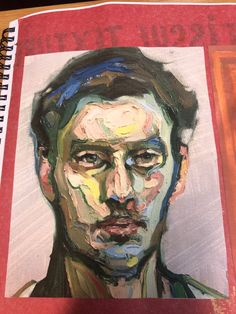 a drawing of a man's face on a notebook