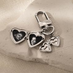 two heart shaped key chains with pictures on them