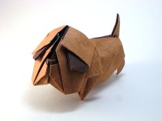 an origami dog made out of brown paper