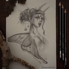 a pencil drawing of a woman's head with feathers and beads hanging from her hair