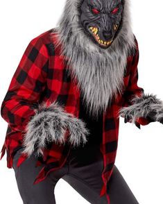 a man in a red and black shirt is wearing a wolf mask with his hands out