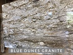 a granite counter top with the words blue dunes granite in front of it and an image of