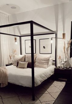 there is a bed with a canopy in the room