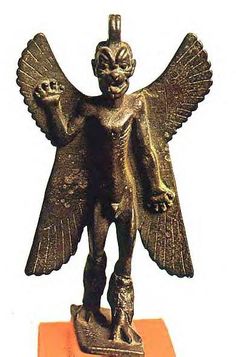 a bronze statue of an angel with outstretched wings on a small orange stand, against a white background
