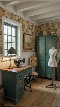 an old fashioned sewing machine in a room with floral wallpaper on the walls and wooden floors