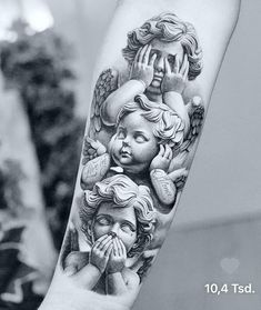 black and white tattoo on the arm of a woman with angel wings covering her eyes