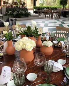 the table is set with flowers and wine glasses