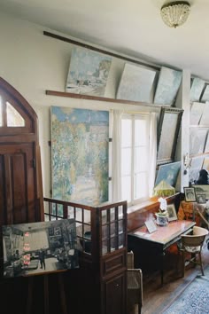 a living room filled with furniture and paintings