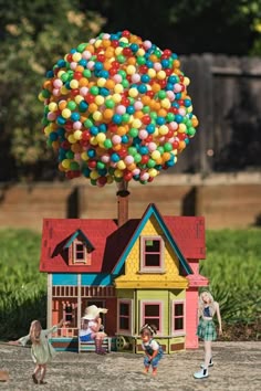 a toy house with a tree made out of balloons