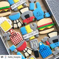 decorated cookies in the shape of fathers day and dad's day items on a tray