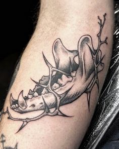 a tattoo on the leg of a man with a shoe