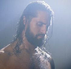 a man with long hair and no shirt on