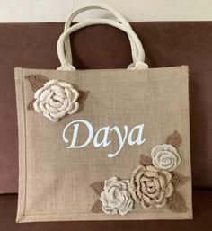 a bag with flowers and the word daya on it
