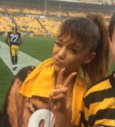 two people posing for a photo at a football game