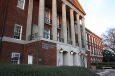 an old brick building with columns and windows