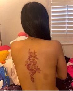 a woman with a tattoo on her back