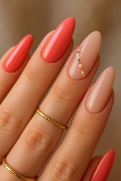 Add a touch of minimalist glam to your summer with these chic coral and nude nails! This elegant set features vibrant solid coral/peach nails perfectly paired with soft nude nails. One accent nail shines with a delicate vertical line of alternating gold and white beads, adding sophisticated sparkle. The graceful long almond shape enhances this modern and refined look. Ideal for any summer occasion, from casual outings to elegant events!  #summernails2025 #coralnails #nudenails #beadednails #almondnails #chicsummernails #elegantnails #minimalistnails #summernailart #nailinspo #glamnails Choral Nails, Summer Holiday Nails Designs, Vacation Nail Ideas Almond, Elegant Almond Nails For Summer, Summer Autumn Nails, Orange Nails Simple, Peach Nail Design Ideas, Coral Nail Inspo, Coral Color Nails
