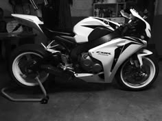 black and white photograph of a motorcycle in a garage