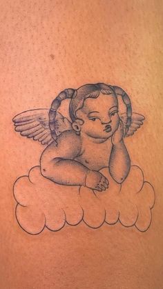 an angel sitting on top of a cloud